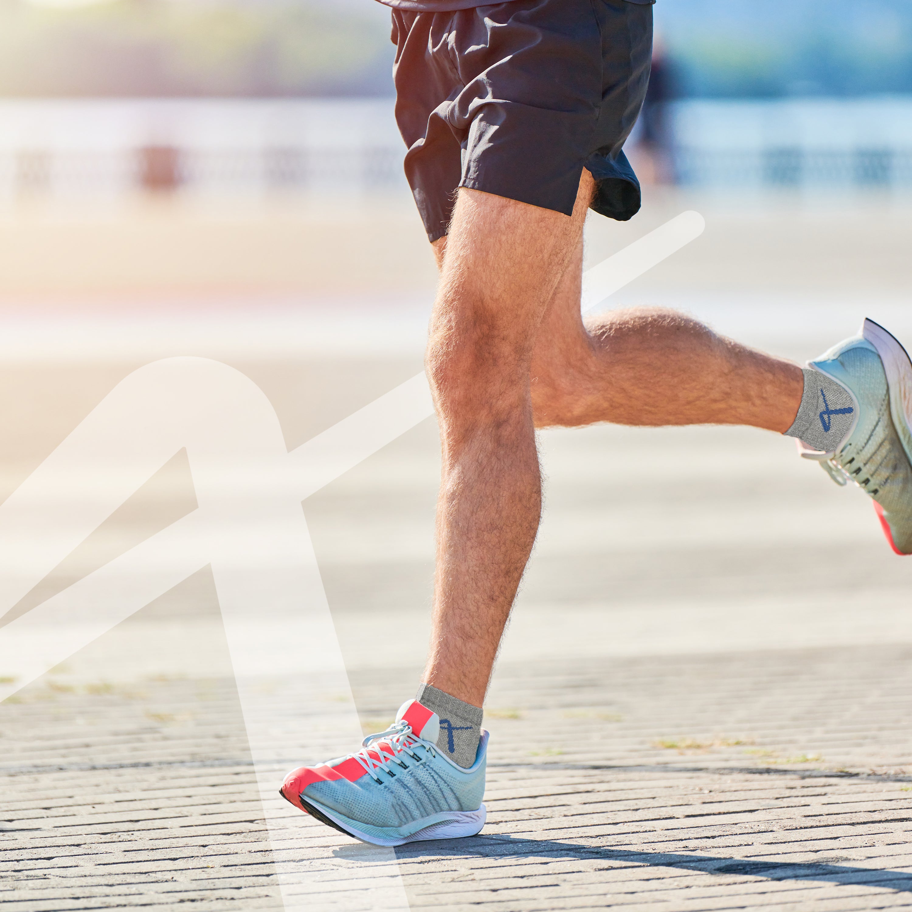 Man running with Triumphant Sports Specialised Activewear Socks Champion Series Ankle Length Grey Blue